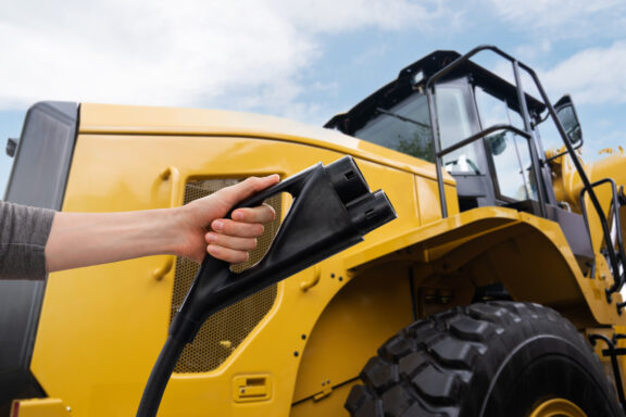 RFA Engineering designed electric heavy equipment featuring a charging plug, highlighting advancements in sustainable construction machinery.