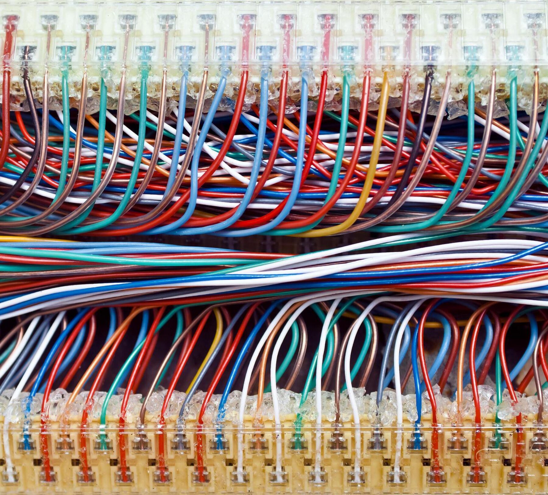 Close-up view of colorful wires used in electronic control systems, illustrating the complexity and integration needed for modern machine automation and control.